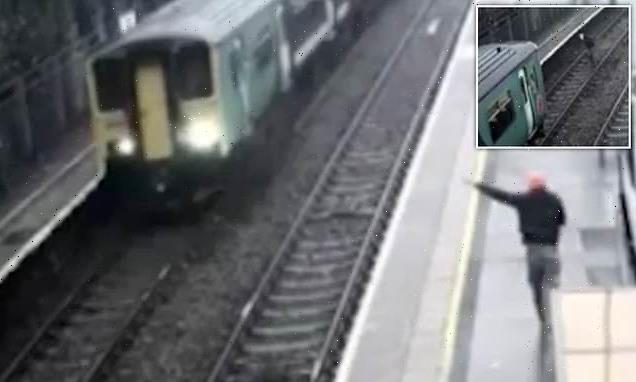 Drunk passenger ran across train tracks before crawling UNDER train