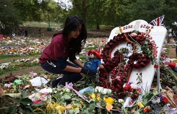 Flowers, cards and Paddington Bears left for the Queen are removed