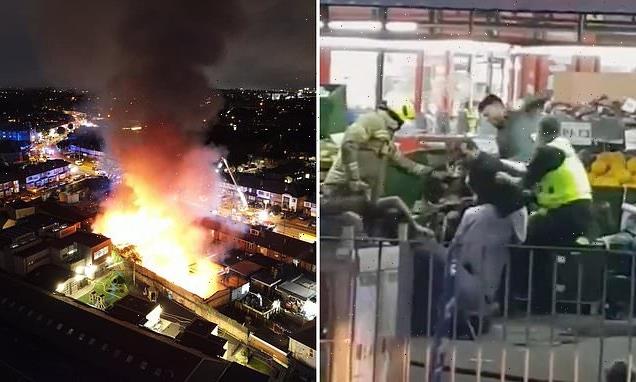 Men brawl and throw FRUIT at each other outside ablaze supermarket