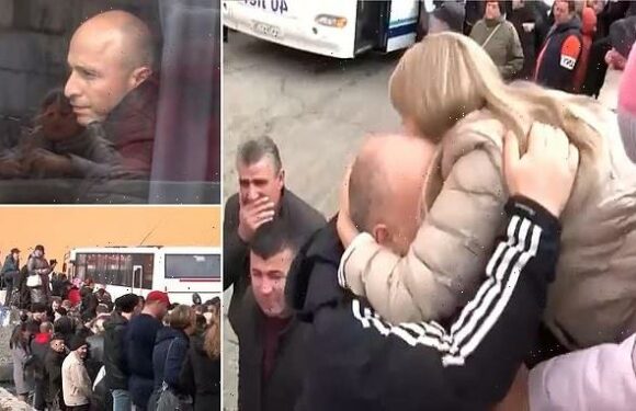 Russian conscripts kiss families goodbye as they board war buses