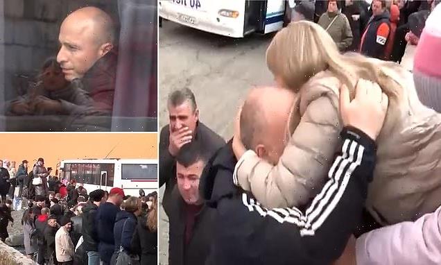 Russian conscripts kiss families goodbye as they board war buses