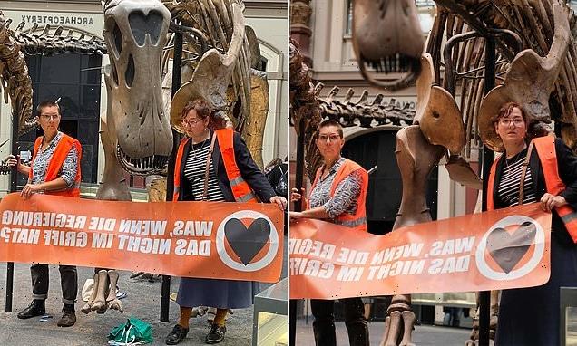 German climate change activists glue themselves to DINOSAUR in Berlin