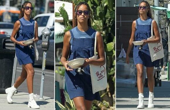 Malia Obama struts in high-heeled combat boots and overall dress
