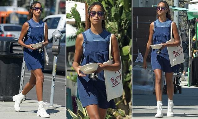 Malia Obama struts in high-heeled combat boots and overall dress