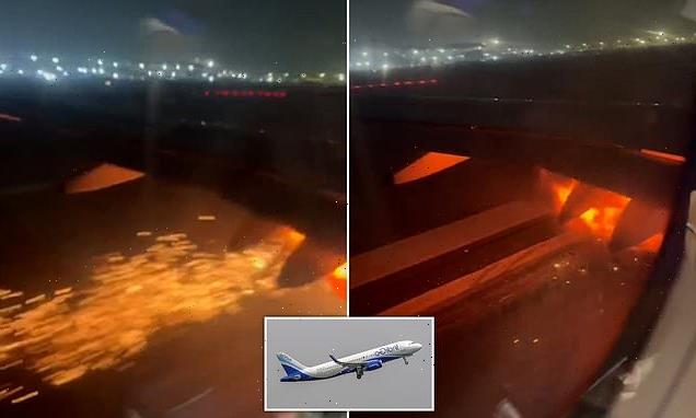 Moment plane's engine bursts into FLAMES during take-off in India