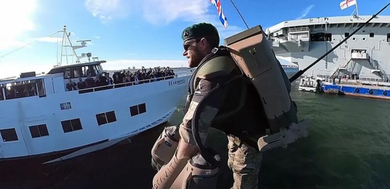 Royal Navy servicemen board HMS Queen Elizabeth with jet packs