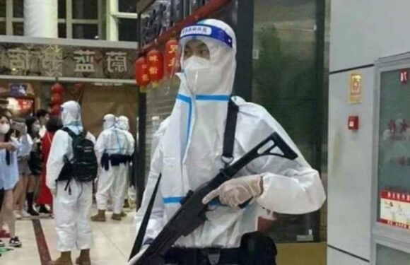 Shocking moment machine gun cops herd terrified families to quarantine camp in disturbing vision of ‘Covid zero’ China | The Sun