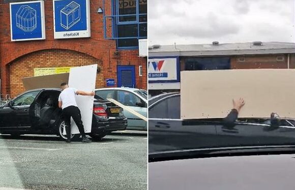 Wickes customer drives off holding giant wooden panel outside of car