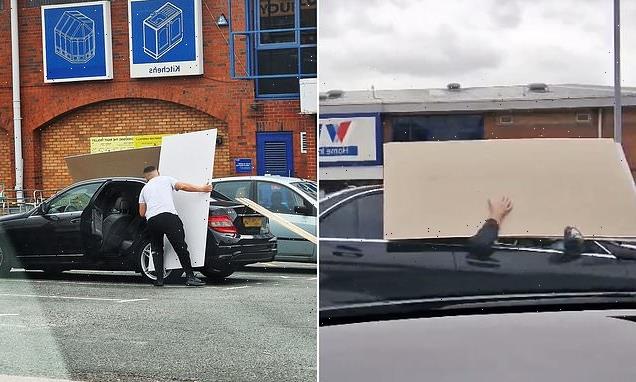 Wickes customer drives off holding giant wooden panel outside of car