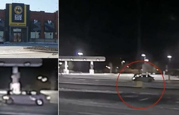 Teens speed off from a Buffalo Wild Wings with employee on top of car