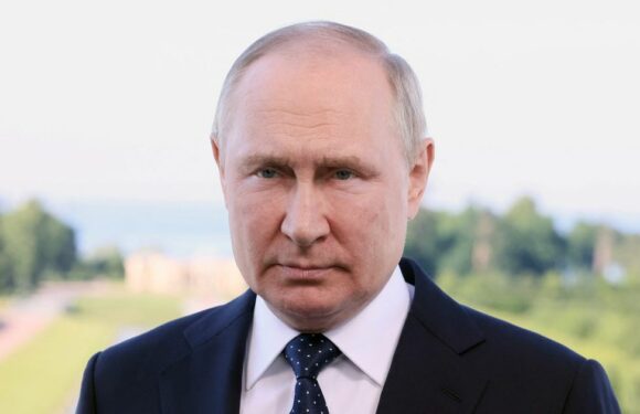 Vladimir Putin’s hand turns purple as he’s seen shaking and clutching chair