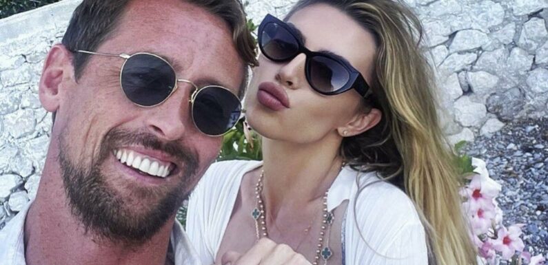 Abbey Clancy shows off toned figure and flashes peachy derrière in tiny bikini