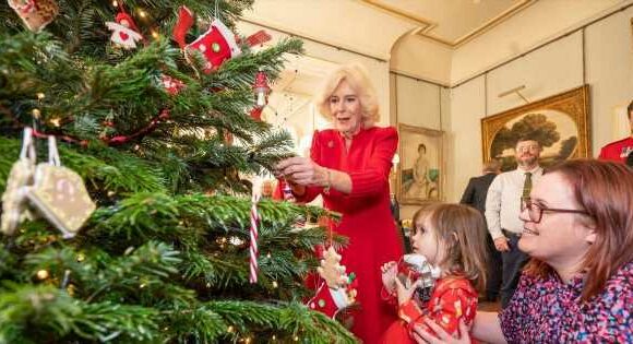Camilla is stunning in red as she decorates Christmas tree at Clarence House