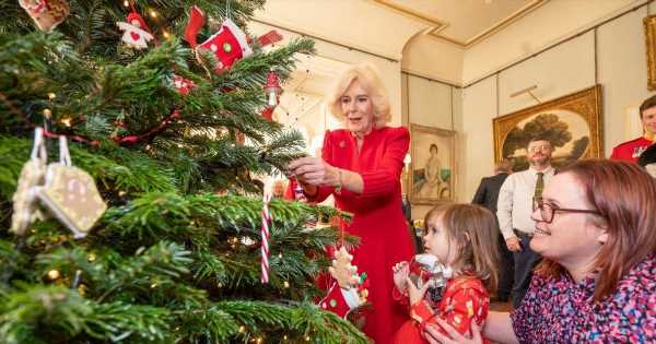 Camilla is stunning in red as she decorates Christmas tree at Clarence House