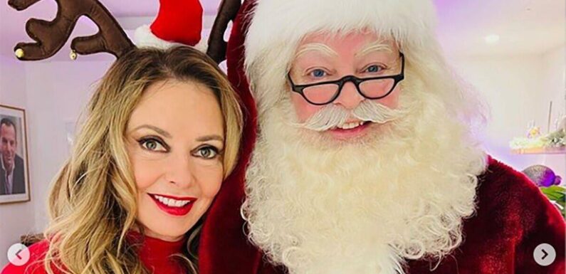 Carol Vorderman flaunts famous curves in sexy red dress for Christmas