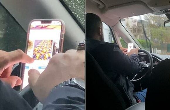 Moment reckless Uber driver browses YOUTUBE on his phone at the wheel