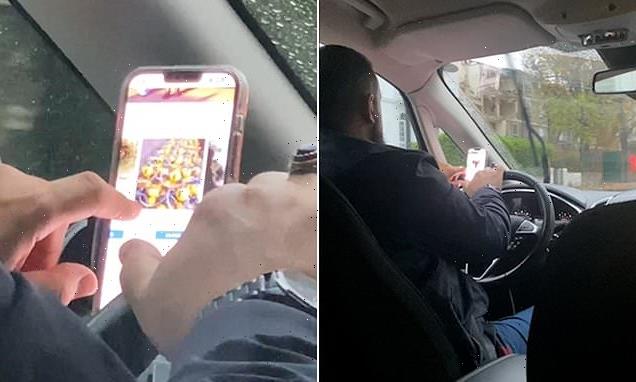 Moment reckless Uber driver browses YOUTUBE on his phone at the wheel