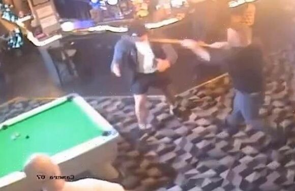 Angry pubgoer is knocked out by man with pool cue in chaotic bar brawl