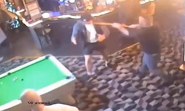 Angry pubgoer is knocked out by man with pool cue in chaotic bar brawl