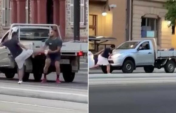 Bizarre moment bystander laughs while filming road rage brawl
