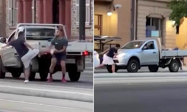 Bizarre moment bystander laughs while filming road rage brawl