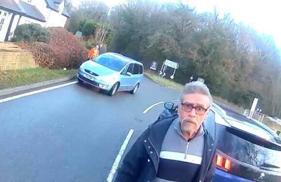 Bizarre moment cyclist's confronted in heated row while car rolls away