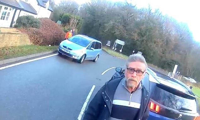 Bizarre moment cyclist's confronted in heated row while car rolls away