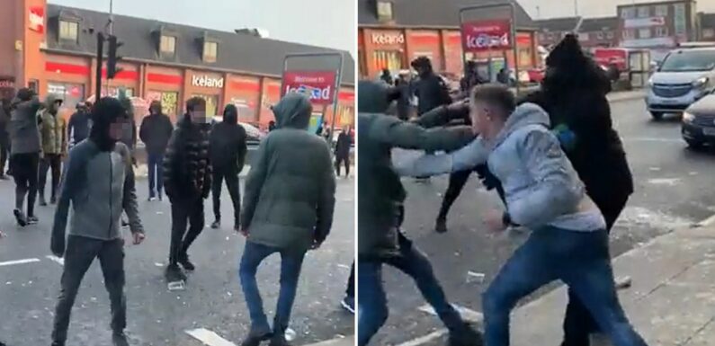 Carnage outside Wetherspoons as hooded yobs stop traffic with wild street brawl