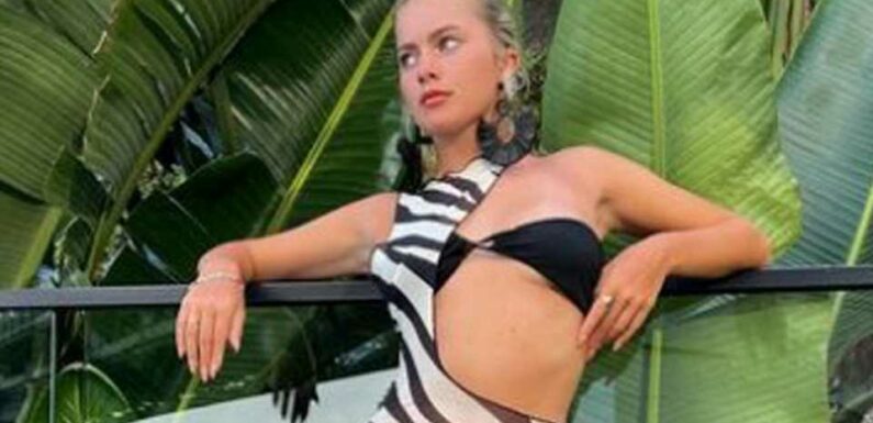 Love Island's Tasha Ghouri flashes her washboard abs in bikini top and barely-there dress on holiday in Australia | The Sun