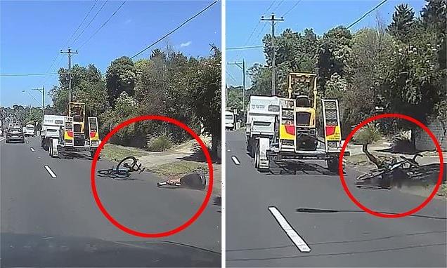Terrifying moment cyclist is knocked to the ground by truck