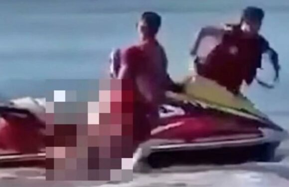 Dramatic moment hero lifeguards desperately try to save shark attack victim after racing him to beach on jet ski | The Sun