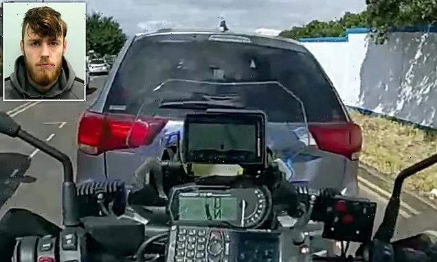 Shocking moment banned driver reverses into motorbike cop