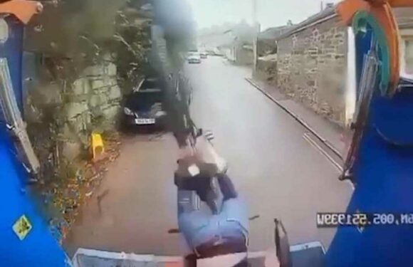 Terrifying moment cyclist topples into back of moving bin lorry after losing control down steep hill | The Sun