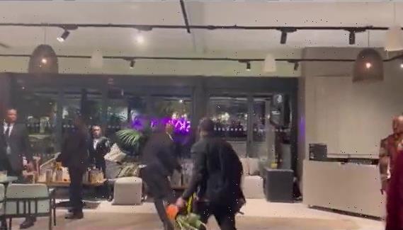 Watch shocking moment men in suits fight in wild brawl – using PLANT POTS as weapons | The Sun