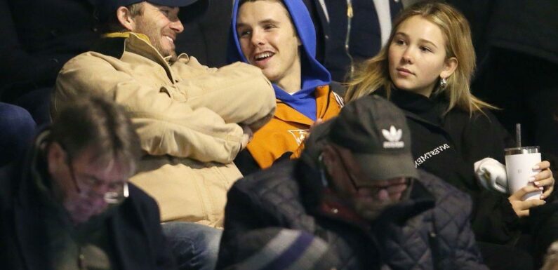 David Beckham and son Cruz wrap up warm to watch Romeo play football