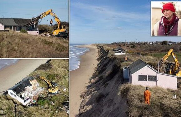 Homeowners look on as digger moves in to destroy their clifftop houses