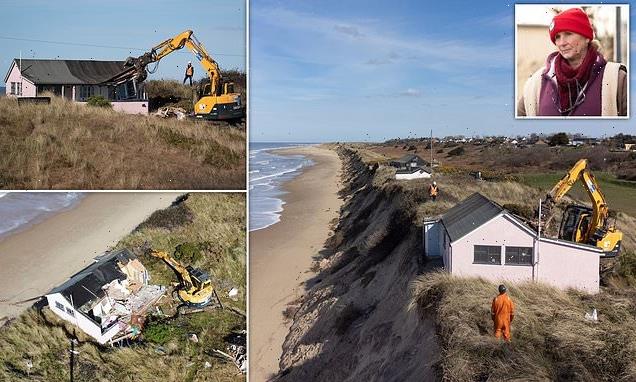 Homeowners look on as digger moves in to destroy their clifftop houses