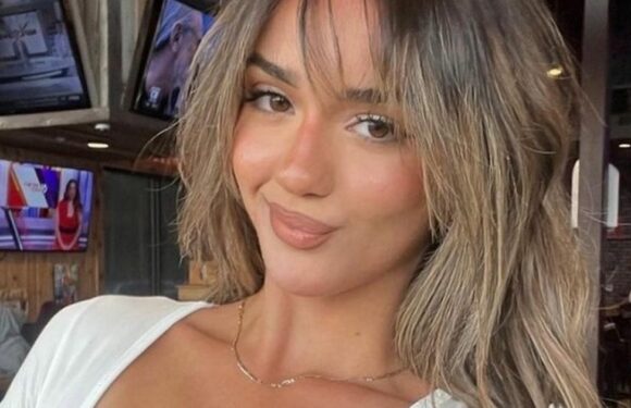 Hooters babe shares cheeky ‘naked’ quip as she flaunts curves in racy uniform