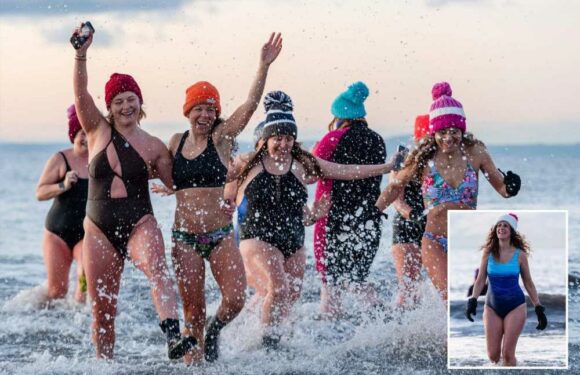 Keen swimmers brave freezing snow as they take a dip in chilly water despite yellow weather warnings | The Sun