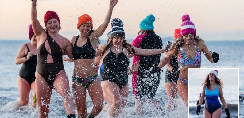 Keen swimmers brave freezing snow as they take a dip in chilly water despite yellow weather warnings | The Sun