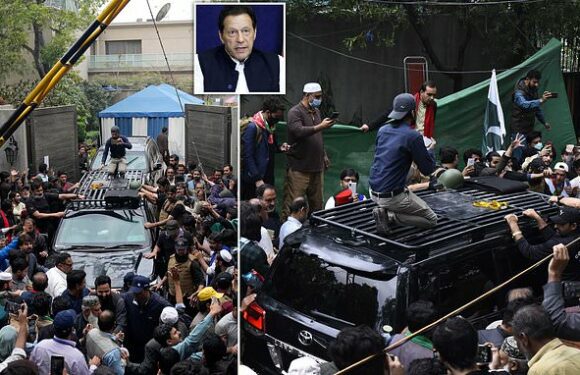 Police storm Imran Khan's home and arrest 30 amid tear gas and bullets