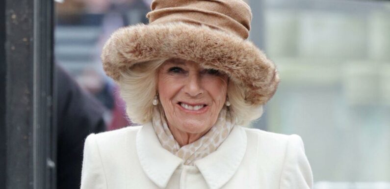 Queen Camilla is in Colchester wearing a Fiona Clare coat