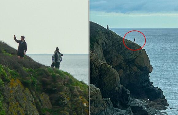 Reckless tourists pose for selfies on edge of 500ft cliff in Cornwall