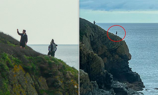 Reckless tourists pose for selfies on edge of 500ft cliff in Cornwall