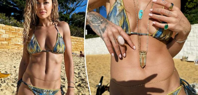 Rita Ora rocks a shimmery metallic bikini and belly chain in Australia