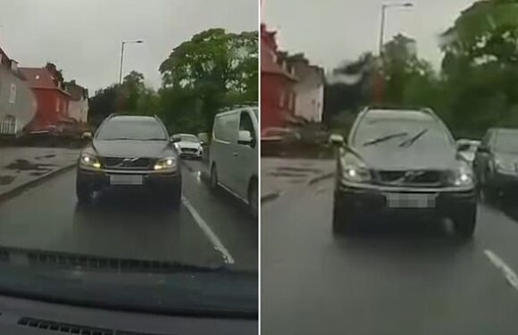 Driver overtakes traffic jam then nearly crashes into oncoming car