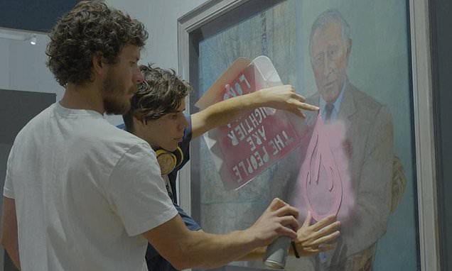 Moment eco vandals spray paint on a portrait of King Charles