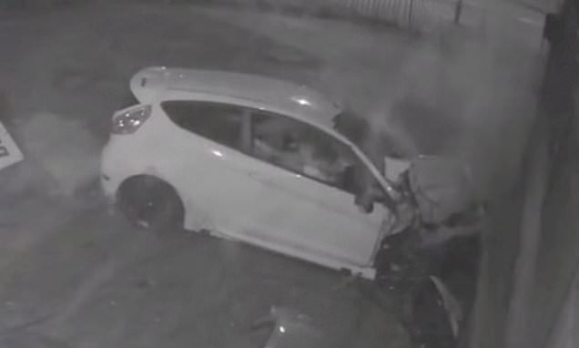 Moment five youngsters are hurt as their car skids into garage wall