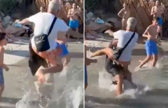 Shocking moment yachtie is floored with flying kick by furious husband for pushing his wife on tourist beach | The Sun