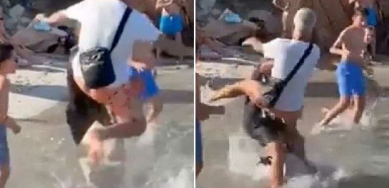 Shocking moment yachtie is floored with flying kick by furious husband for pushing his wife on tourist beach | The Sun